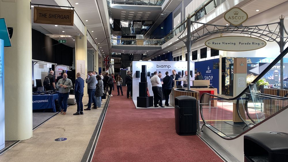 Long shot view of multiple stands at TechXPO, showcasing various technology exhibitors