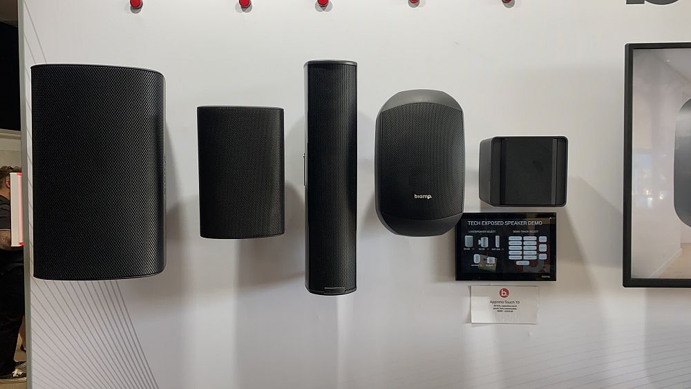 Biamp products displayed on a wall, featuring various speakers.