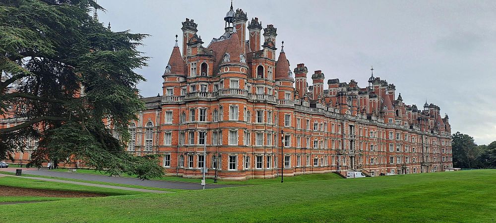 View of the outdoor area at Royal Holloway, University of London, highlighting the campus architecture and surrounding landscape